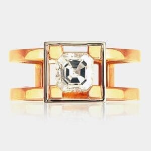 Handmade, contemporary style engagement ring featuring picture-frame set Asscher cut diamond with split band in 18ct rose gold.