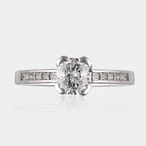 1.10 carat Cushion cut diamond ring with shoulder princess cut diamonds in 18ct white gold.