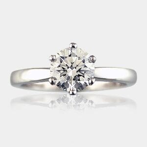 Round brilliant cut diamond engagement ring with 6 claws and slightly rounded band.