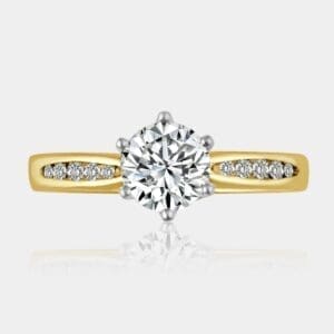 Round brilliant cut diamond engagement ring with shoulder diamonds in a marquise shape.