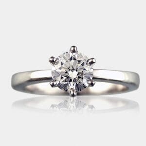 Round brilliant cut engagement ring with rounded white gold band.