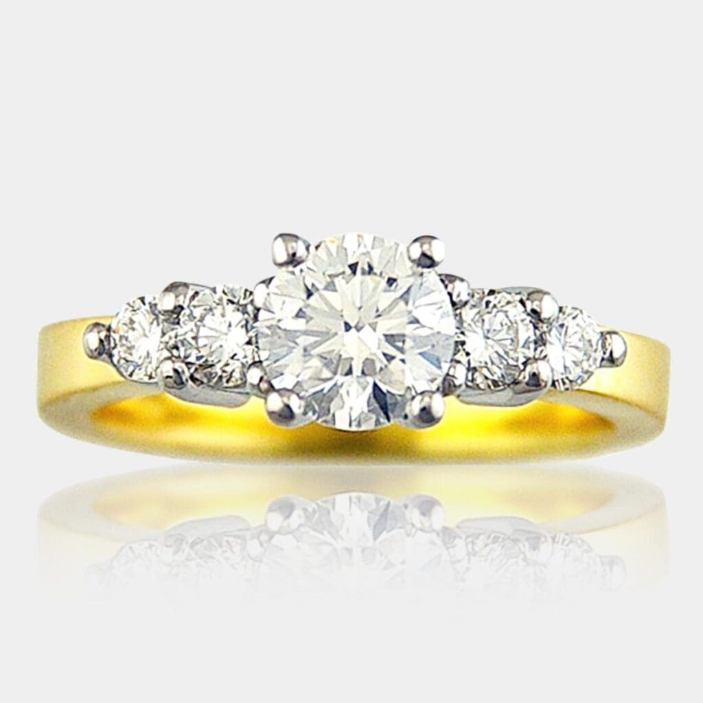 5 stone round brilliant cut diamond ring in 18ct white settings and yellow gold band.