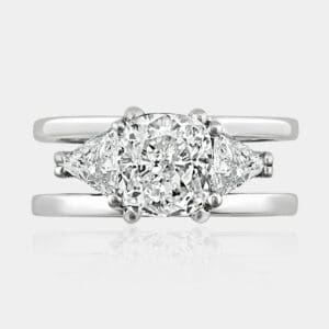 1.60 carat Cushion cut diamond ring with trilliant cut diamonds on each side.