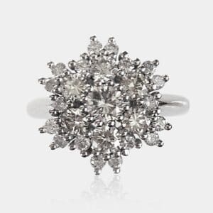 Handmade, cluster style engagement ring or fashion ring with round brilliant cut diamonds surrounding the centre stone, creating a star or flower shape.