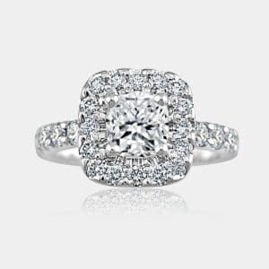 Cushion cut diamond centre with surround and shoulder diamonds.