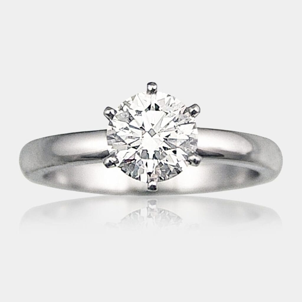 Handmade round brilliant cut solitaire diamond engagement ring with six claw seting in 18ct white gold.