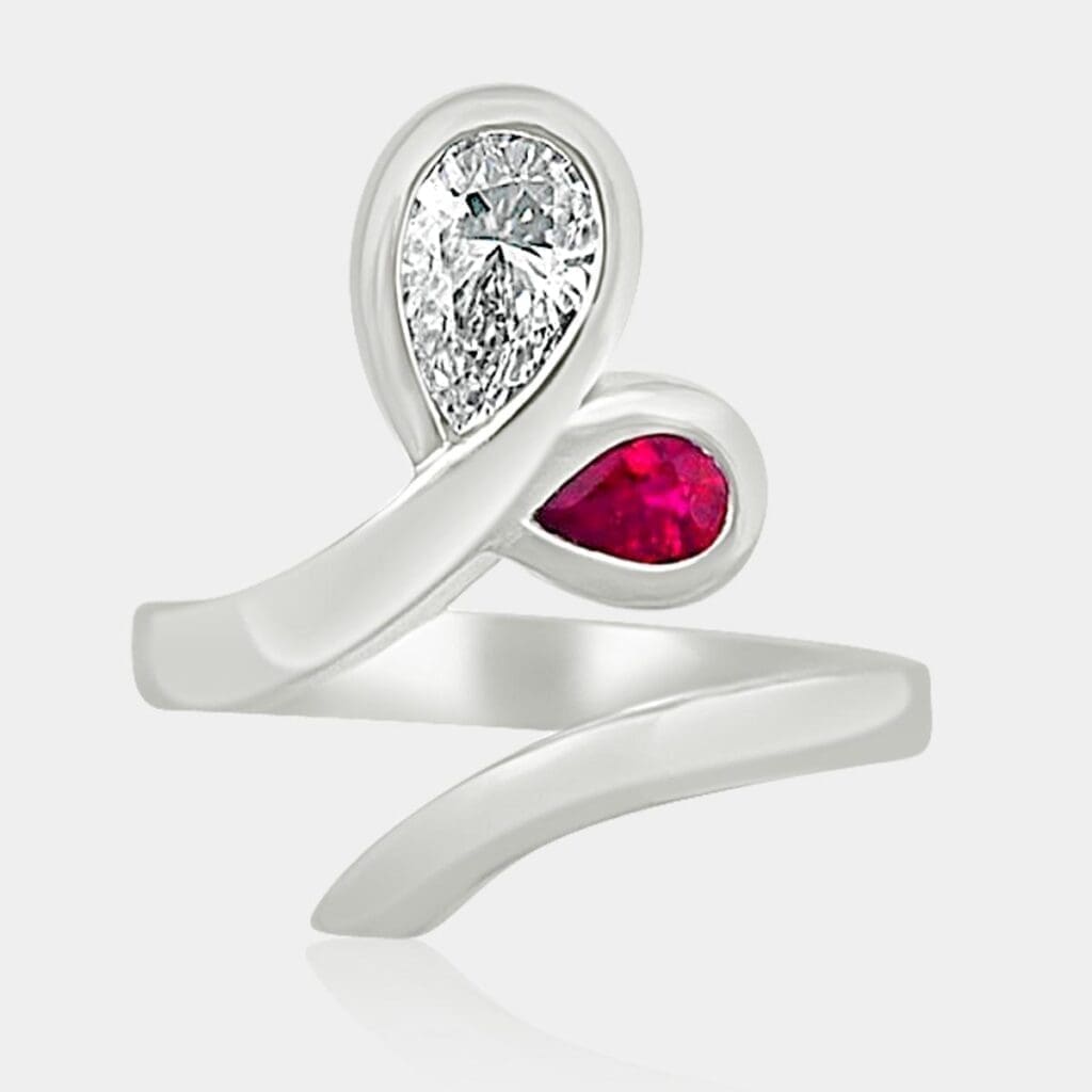 Pear shape diamond & ruby ring in a leaf/petal design.