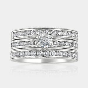 0.35 carat Round brilliant cut diamond ring with channel set shoulder diamonds and two matching diamond wedding bands, milgrain finish.